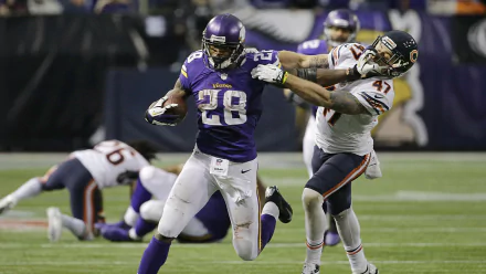 Adrian Peterson, wearing jersey number 28, evades a defender during an NFL game, showcasing his dynamic athleticism in this HD sports wallpaper.