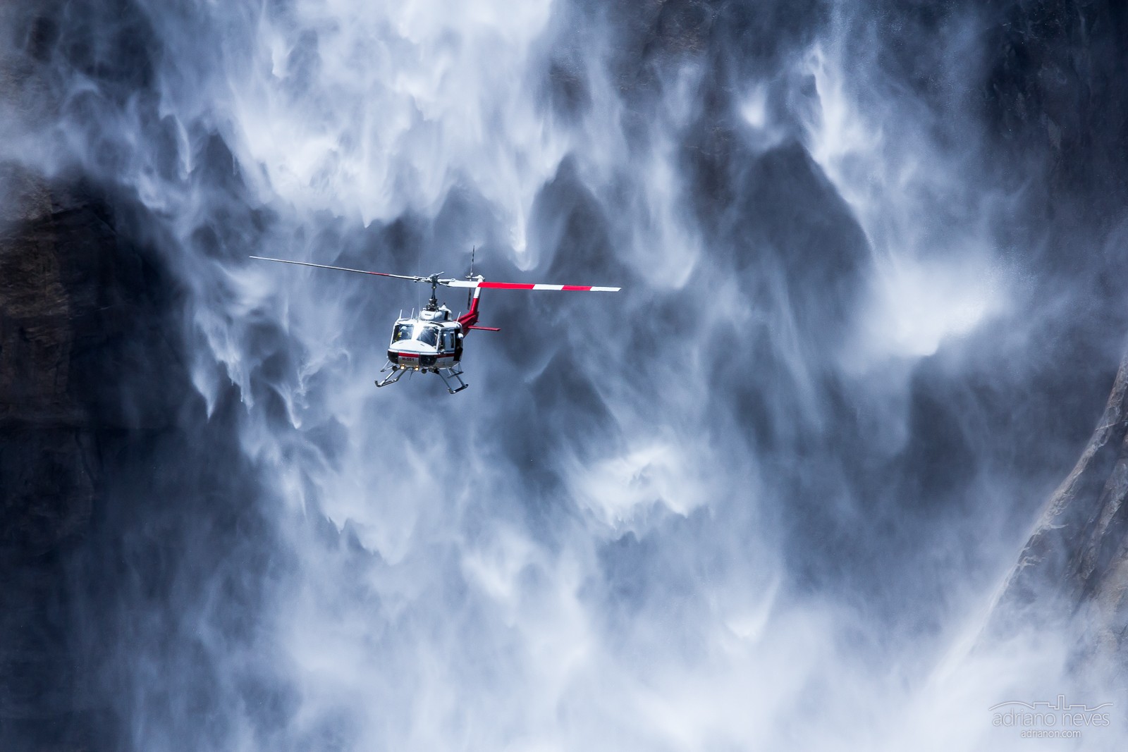 Search & rescue helicopter near Yosemite waterfall, USA by Adriano Neves