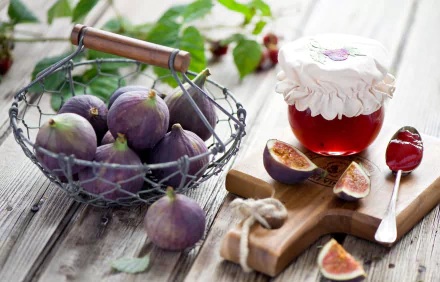 A 4K Ultra HD still life of fresh figs in a wire basket with a jar of homemade jam and a spoon on a rustic wooden table, showcasing vibrant fruit and food textures.
