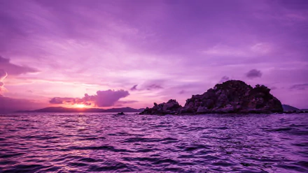 HD wallpaper of a stunning purple sunset over the ocean, highlighting Pelican Island's rocky silhouette. The serene nature scene displays vibrant colors and is tagged with nature, island, and ocean.