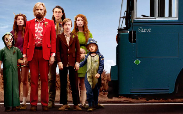 HD PC desktop wallpaper and background from the movie Captain Fantastic showing a rugged family in eclectic clothing lined up beside a blue bus under a clear sky.