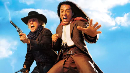 HD desktop wallpaper featuring Owen Wilson as Roy O'Bannon and Jackie Chan as Chon Wang from the movie Shanghai Noon, against a bright blue sky background.