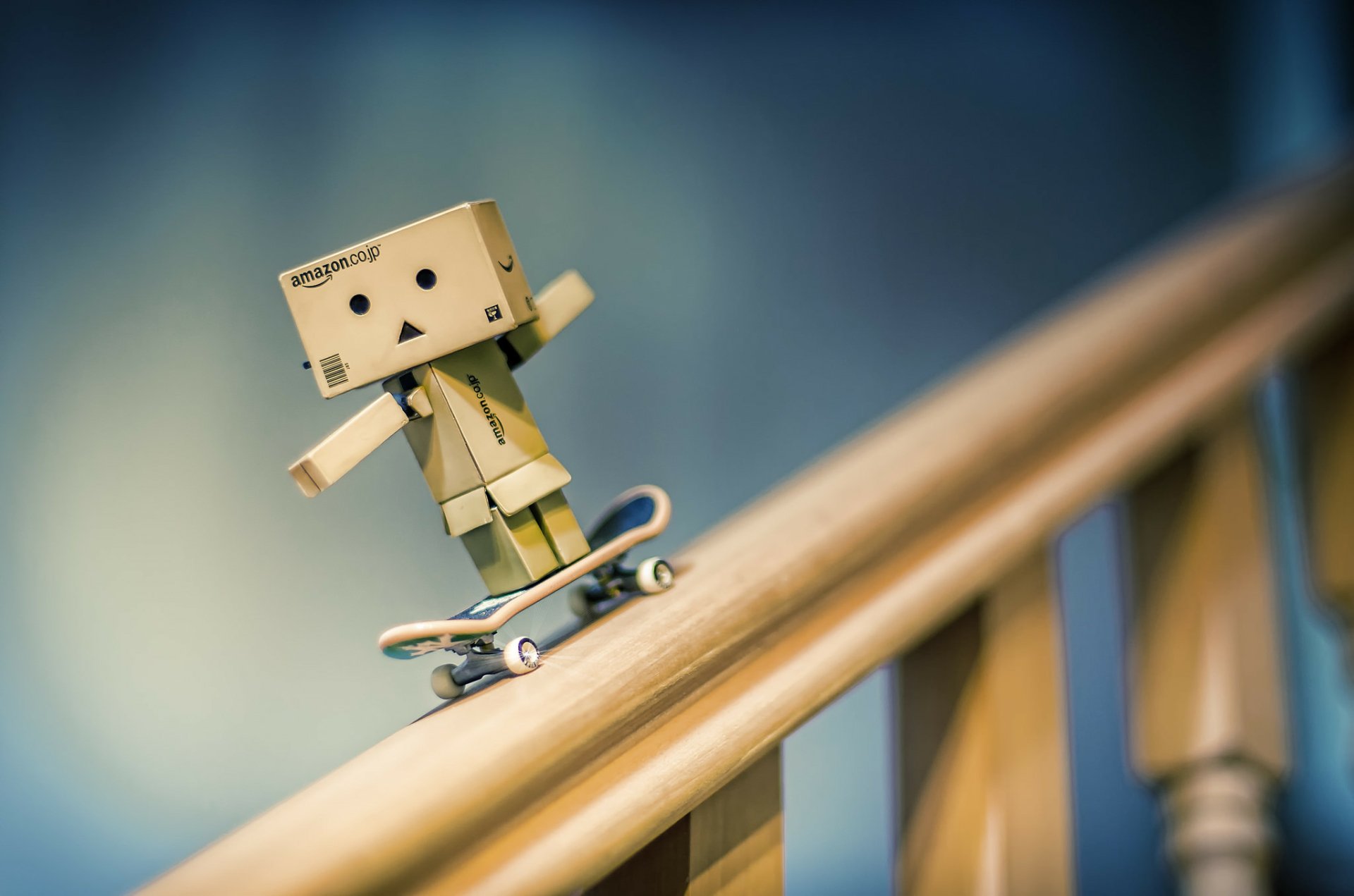 Blurred background with a Danbo figure skateboarding down a railing, creating a dynamic HD PC desktop wallpaper and background image.