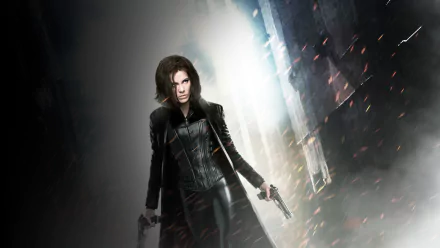 HD PC desktop wallpaper and background from the movie Underworld: Awakening — a leather-clad female warrior holds twin pistols amid smoky, ember-lit urban ruins.
