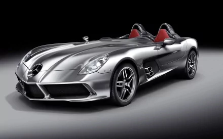 HD desktop wallpaper of a sleek silver Mercedes-Benz SLR McLaren Roadster sports car against a dark gradient background.
