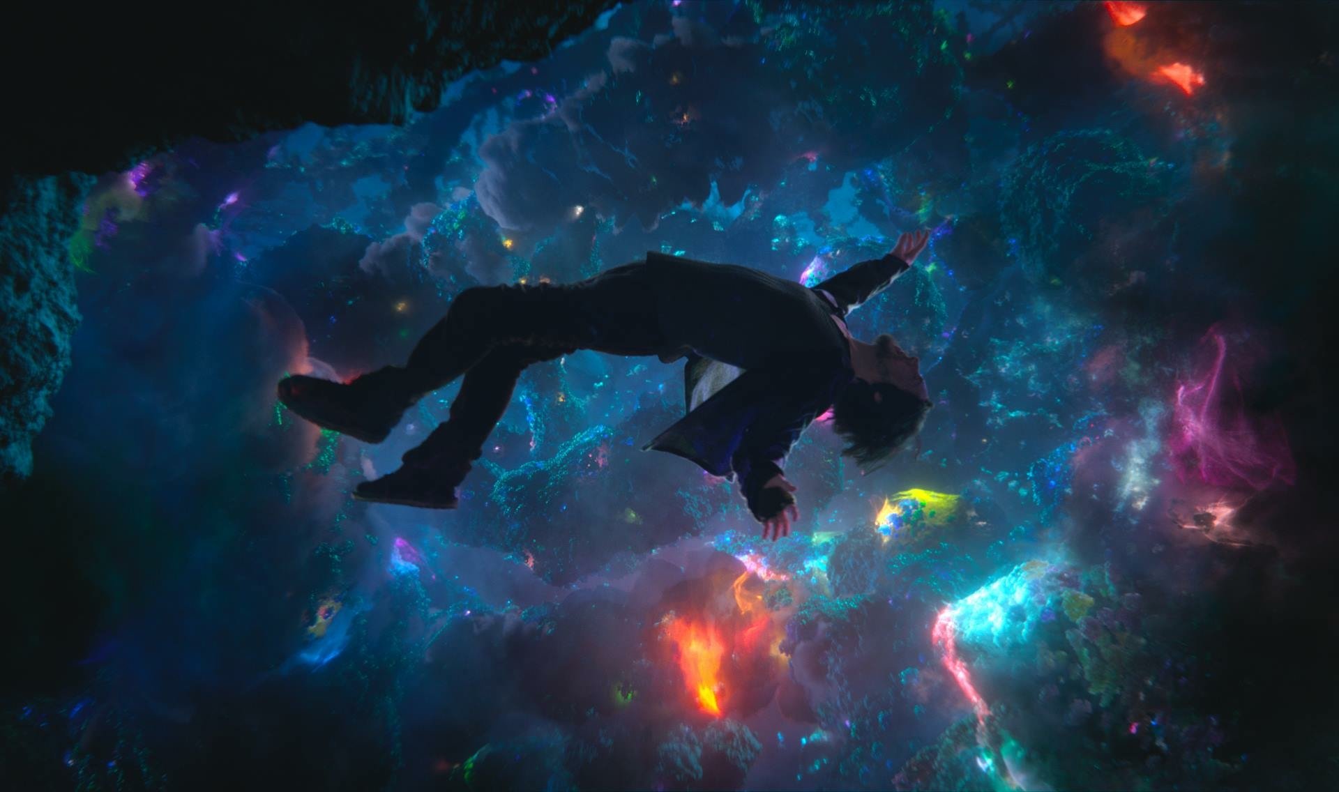 HD desktop wallpaper featuring a scene from the movie Doctor Strange, depicting a figure floating in a mystical, colorful, cosmic environment.