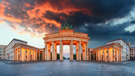 A stunning view of the Brandenburg Gate in Berlin, Germany, illuminated against a dramatic sky, showcasing its grand architecture and historical significance.