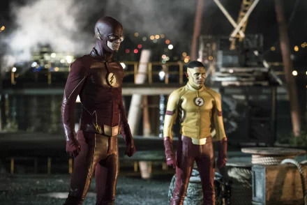 HD wallpaper featuring Keiynan Lonsdale as Kid Flash (Wally West) and Grant Gustin as Flash (Barry Allen) from the TV show The Flash (2014), standing in their superhero suits.
