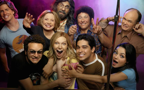 HD PC desktop wallpaper: colorful group portrait of characters from the TV show That '70s Show, smiling and posing against a purple-lit backdrop.