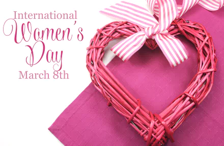 Pink heart-shaped decoration with striped ribbon on a pink background, featuring International Women's Day March 8th text, in 8K Ultra HD quality.