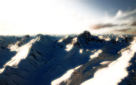 Snowy mountain range bathed in soft glow under a bright sky, captured in HD for a stunning PC desktop wallpaper and background.