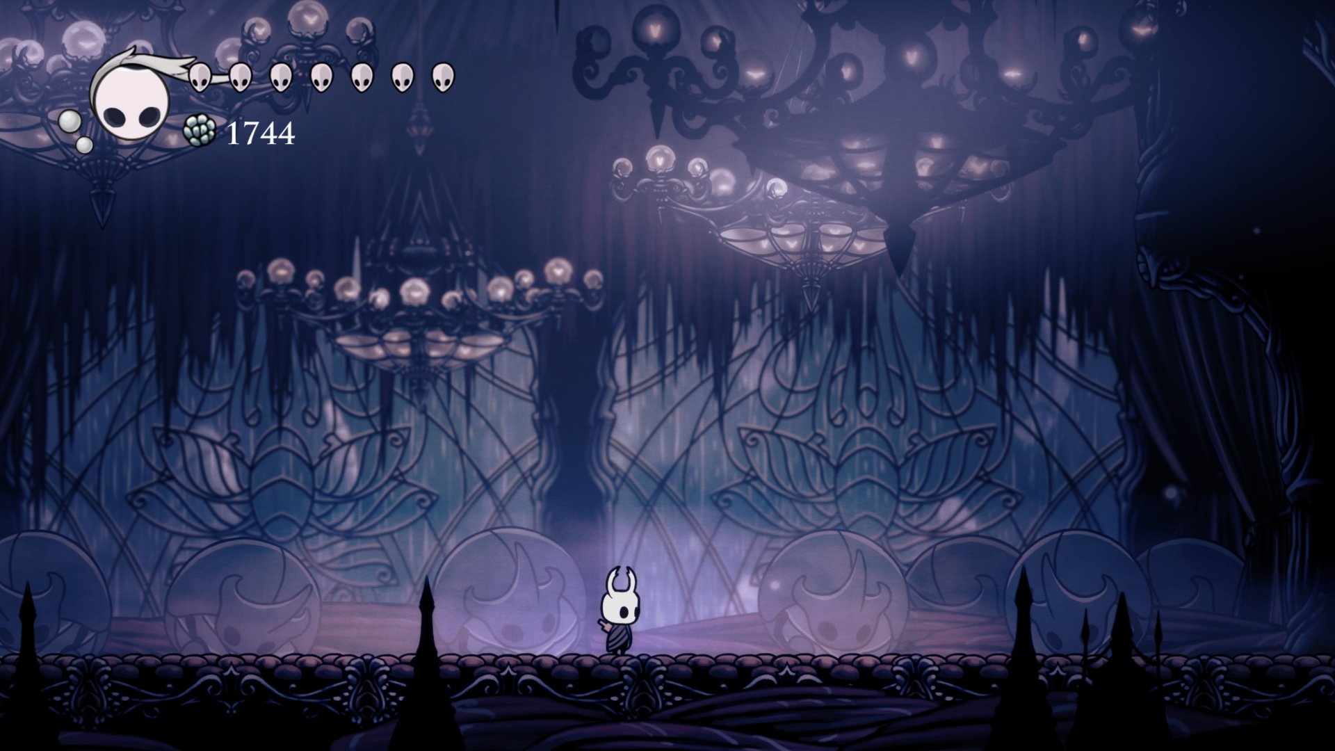 Hollow Knight video game 4K Ultra HD PC desktop wallpaper: lone white-masked knight stands in a vast purple cavern beneath glowing chandelier-like orbs.