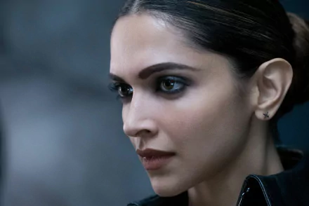 Close-up of Deepika Padukone's character in the movie xXx: Return of Xander Cage. The HD desktop wallpaper showcases her intense expression with a dark, blurred background.