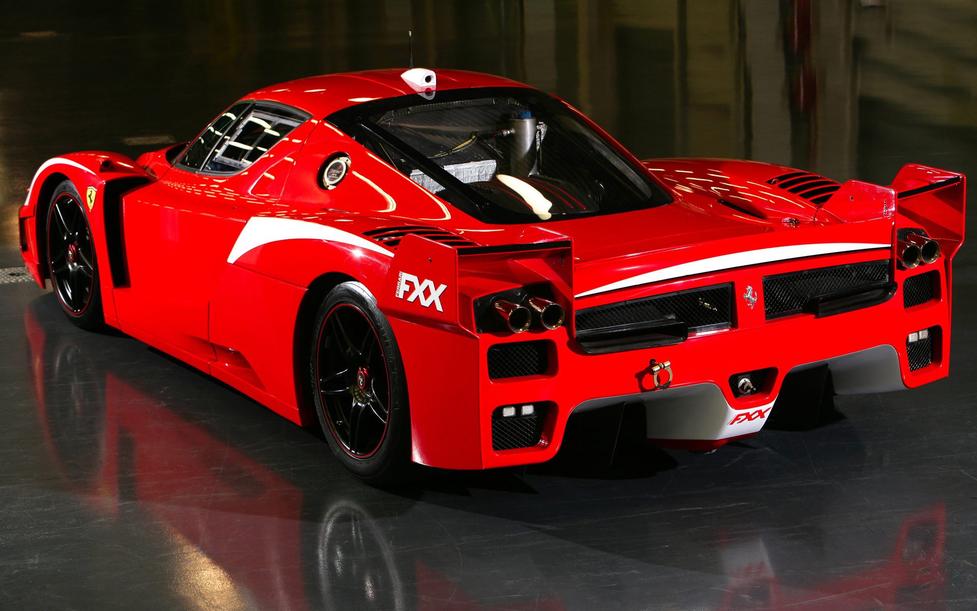 HD desktop wallpaper featuring a striking red Ferrari car, showcasing its sleek design and powerful form. The vehicle stands out as a symbol of luxury and high performance.