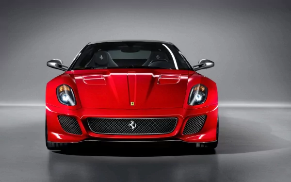 Front view of a red Ferrari 599 GTO grand tourer centered on a neutral gray backdrop, rendered as an HD PC desktop wallpaper.