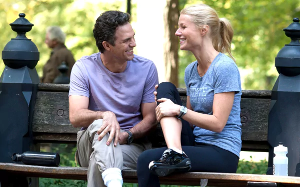 HD PC desktop wallpaper: two people laughing on a park bench in a sunlit scene from the movie Thanks for Sharing.