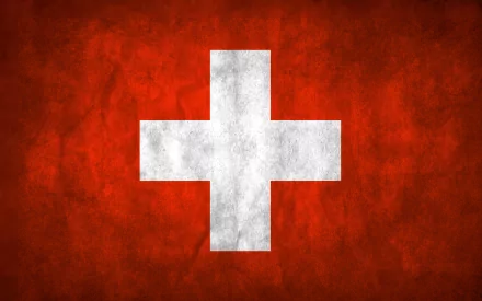 A high-definition desktop wallpaper featuring the flag of Switzerland, showcasing a prominent white cross on a bold red background.