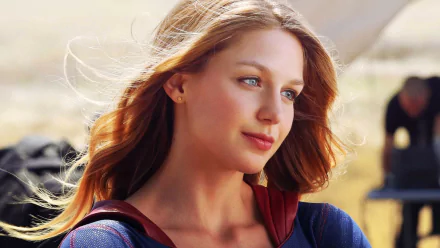 HD desktop wallpaper featuring Melissa Benoist as Supergirl from the TV show Supergirl, with a serene outdoor background.