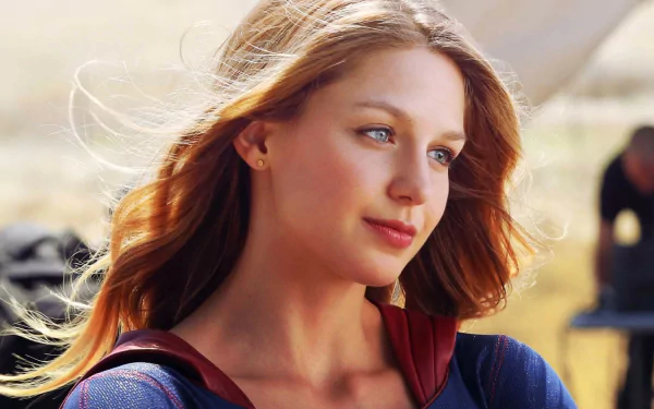 HD desktop wallpaper featuring Melissa Benoist as Supergirl from the TV show Supergirl, with a serene outdoor background.