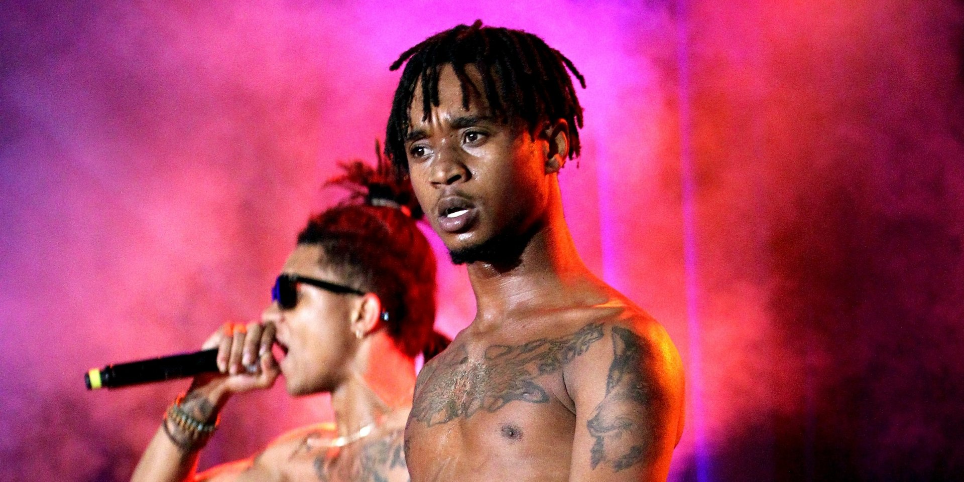 Rae Sremmurd performing on stage, vibrant pink and purple background, HD desktop wallpaper.