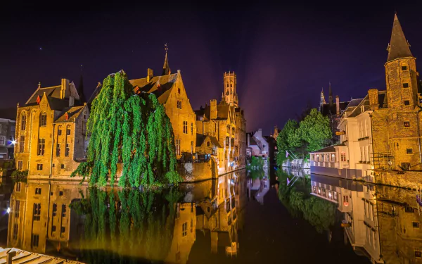 Night view of Bruges town in Belgium with historic houses and their reflections in a tranquil canal, captured in HD for a vivid desktop wallpaper background.