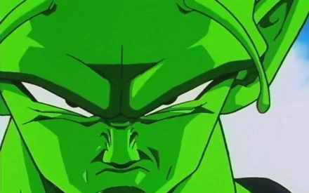A close-up of Piccolo from Dragon Ball, showcasing his intense expression and iconic green skin, serves as a striking HD anime wallpaper background.