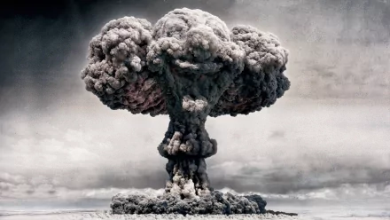 A vivid HD desktop wallpaper featuring a mushroom cloud from a nuclear explosion, with an eerie semblance of a clown face formed by the cloud's turbulence.