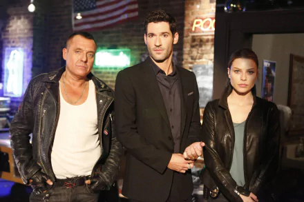 HD wallpaper featuring Tom Sizemore, Tom Ellis, and Lauren German from the TV show Lucifer. They are standing together in a dimly lit room, with a neon sign and brick wall in the background.