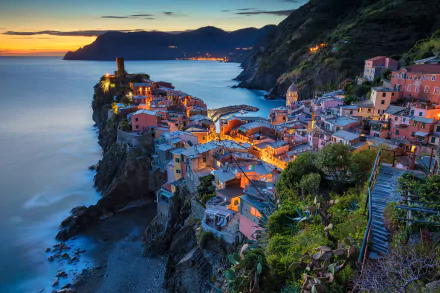 Vernazza, Cinque Terre, Italy at night — colorful cliffside houses and village lights overlooking the harbor, a man-made coastal settlement; HD PC desktop wallpaper/background.