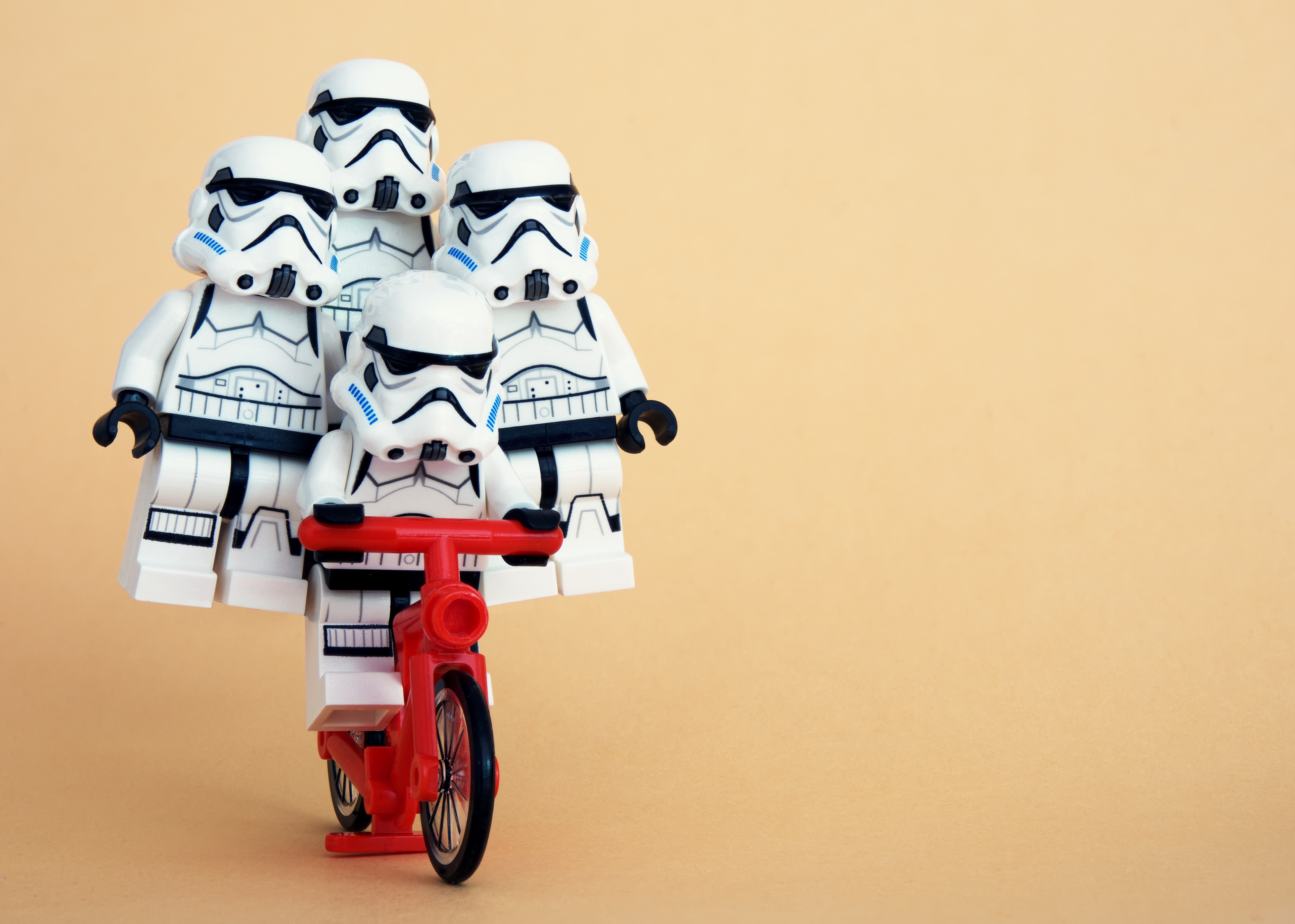 Four Stormtroopers balanced on a Bike