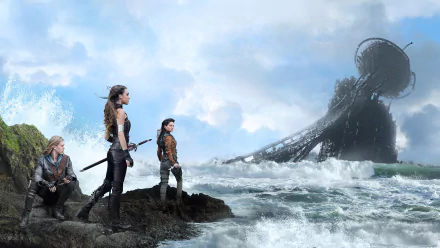 HD PC desktop wallpaper featuring characters from the TV show The Shannara Chronicles standing on rocky shore with waves and a large futuristic structure in the background.