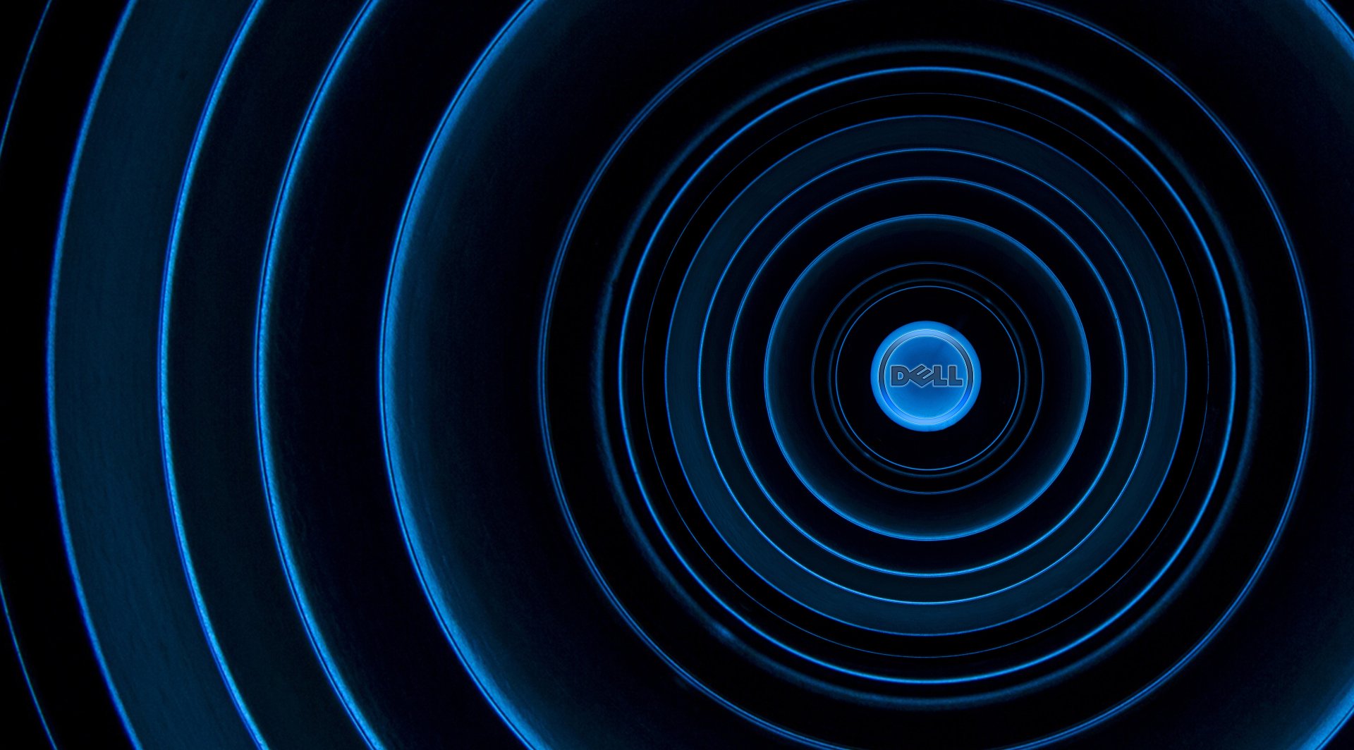 Dell 2K Quad HD PC desktop wallpaper featuring concentric glowing blue rings radiating from a central Dell logo on a dark technological backdrop.