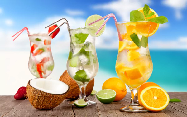 A vibrant 4K Ultra HD wallpaper featuring refreshing summer cocktails with orange, strawberry, coconut, and lime garnishes set against a bright ocean backdrop.