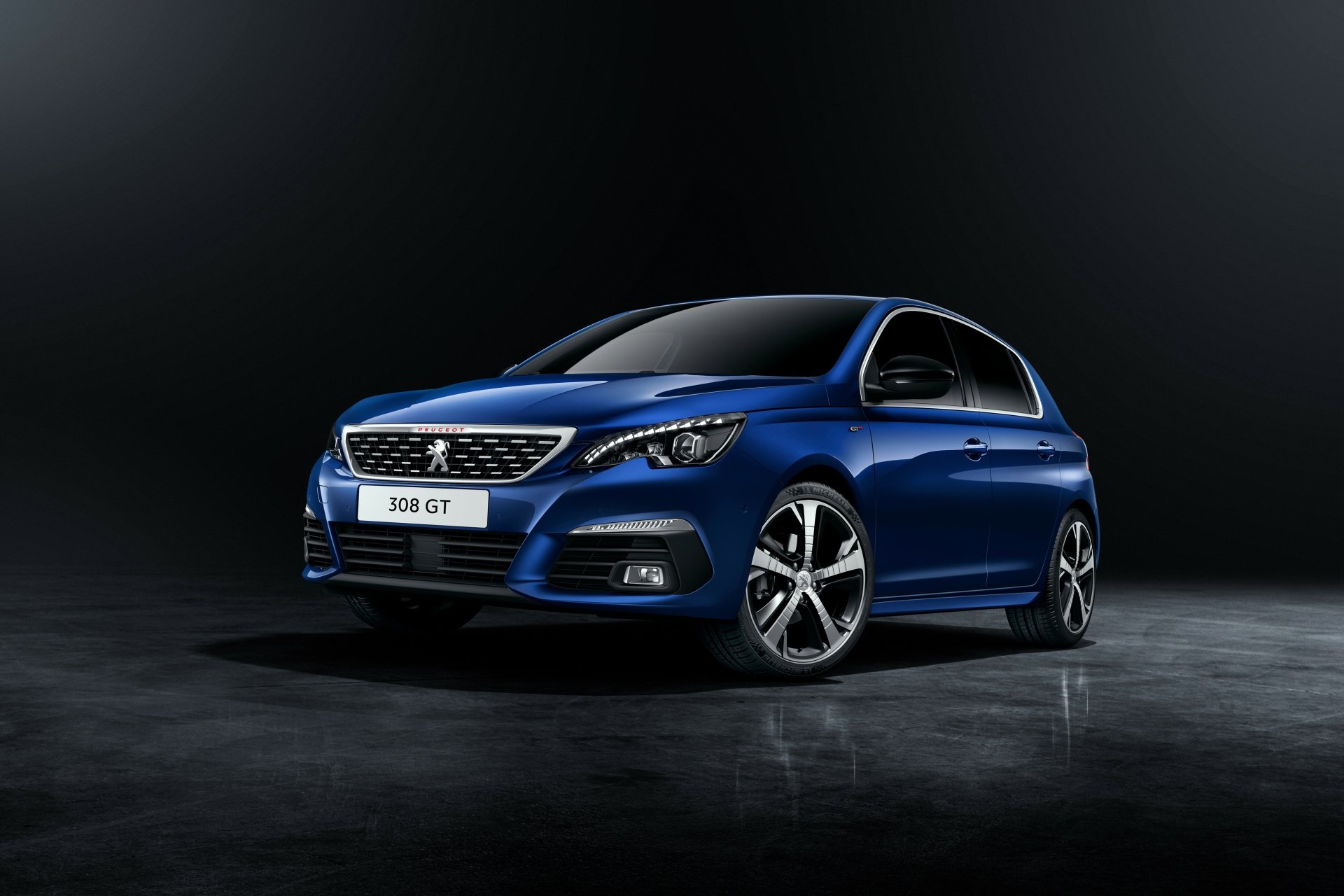 A sleek blue Peugeot 308 GT car showcased against a dark background in 4K Ultra HD, designed as a crisp PC desktop wallpaper and background.