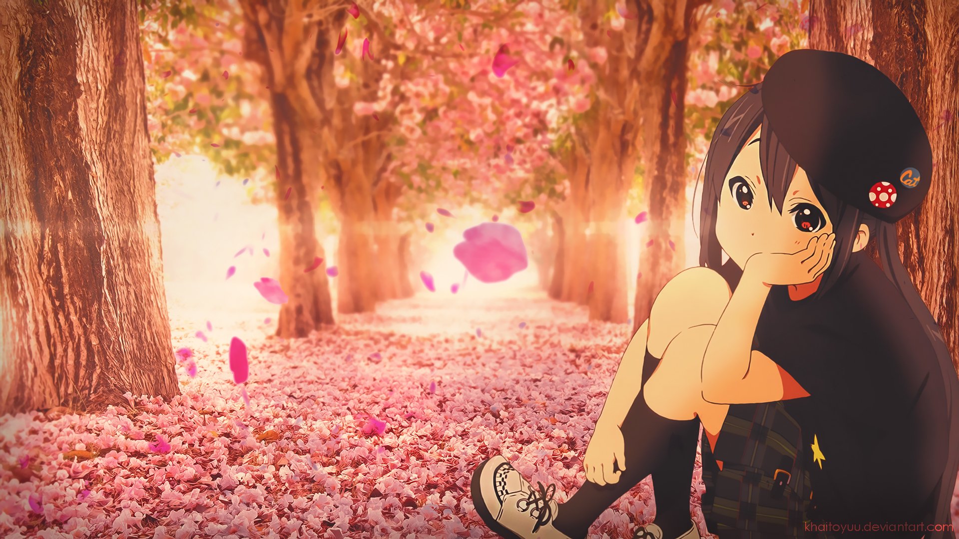 HD PC desktop wallpaper featuring Azusa Nakano from the anime K-ON! sitting amidst a pink cherry blossom path with petals gently falling around her.