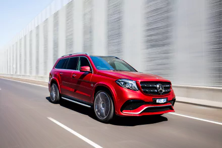 Red Mercedes-Benz GL-Class SUV captured in motion blur on a highway, showcased as a 4K Ultra HD desktop wallpaper.