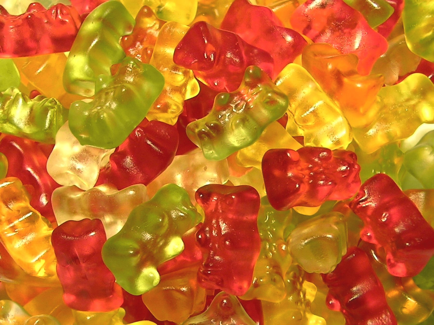 A vibrant HD wallpaper featuring a colorful array of gummy bears in various shapes and flavors, showcasing their playful appeal and tempting sweetness.