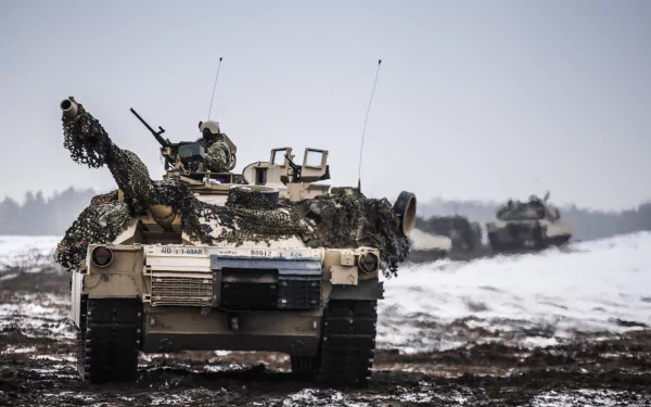 A high-resolution 4K Ultra HD image of an M1 Abrams tank covered in camouflage gear, positioned in a snowy, muddy military environment.