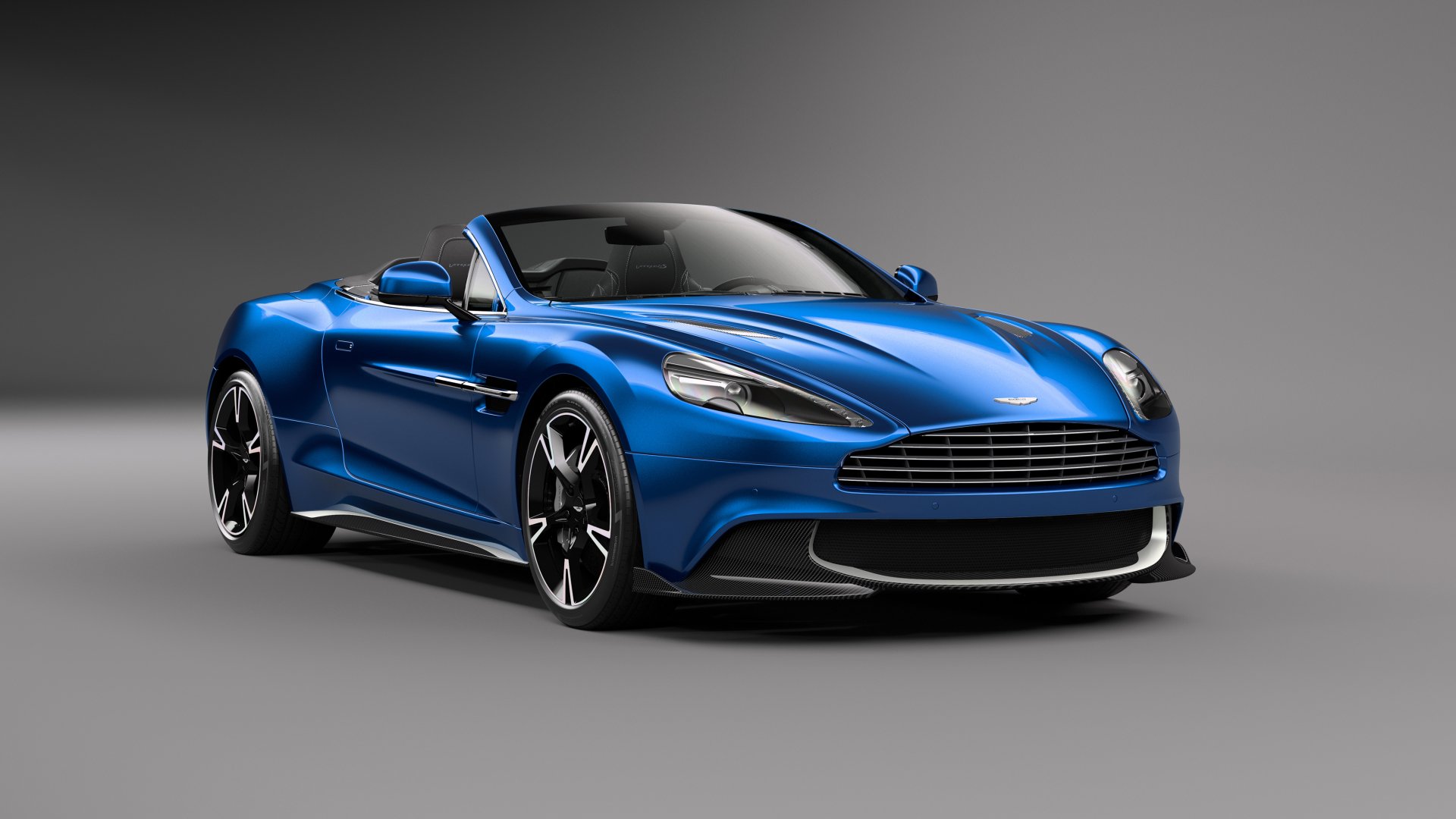 A blue Aston Martin Vanquish S supercar, a sleek grand tourer, showcased against a gray background in 4K Ultra HD.
