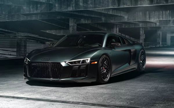 A sleek green Audi R8 V10 supercar parked in a dimly lit concrete garage, captured in stunning 4K Ultra HD detail.