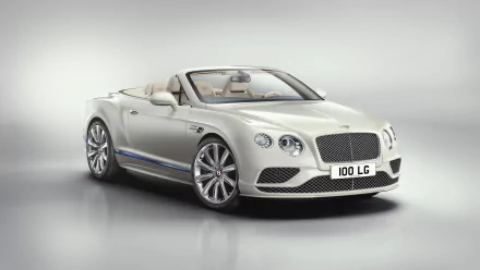 HD desktop wallpaper featuring a white Bentley Continental GT cabriolet. The luxurious car is showcased with its top down, highlighting its sleek design and sophisticated features.