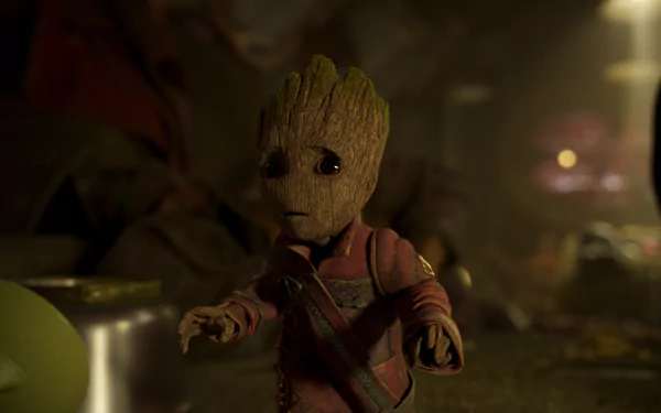 HD desktop wallpaper featuring Baby Groot from Guardians of the Galaxy Vol. 2. Baby Groot stands in a dimly lit environment, wearing his red outfit, showcasing the character's adorable expression and detailed texture.