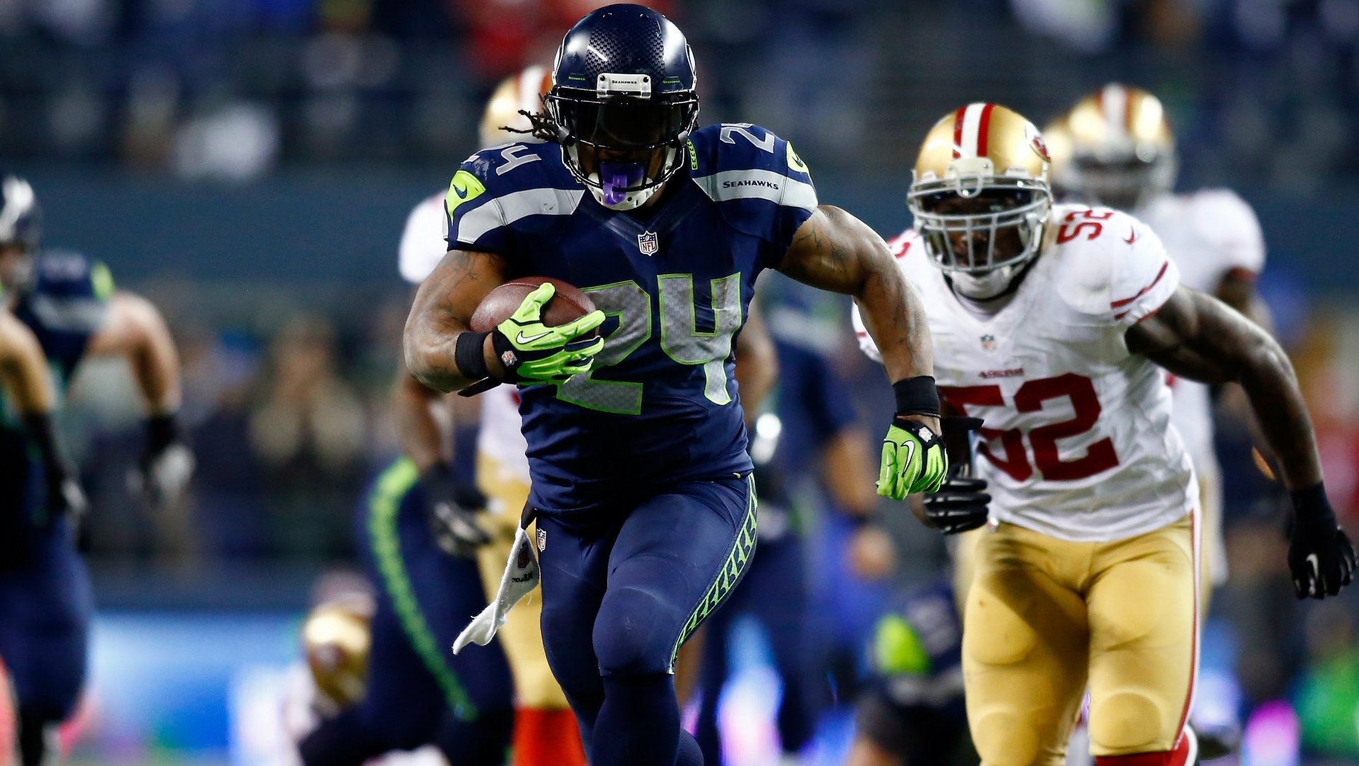 HD desktop wallpaper featuring Seattle Seahawks player Marshawn Lynch in action on the football field.