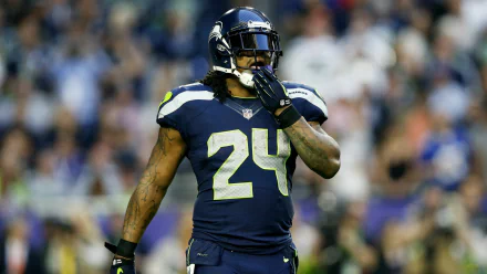 HD wallpaper featuring Seattle Seahawks player #24 on the field, embodying the intense spirit of the game.