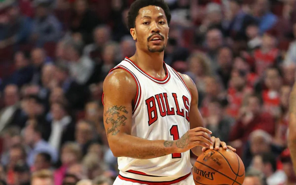 HD desktop wallpaper featuring Derrick Rose in a Chicago Bulls jersey, poised with a basketball on the court.