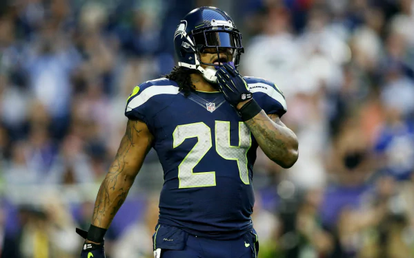 HD wallpaper featuring Seattle Seahawks player #24 on the field, embodying the intense spirit of the game.
