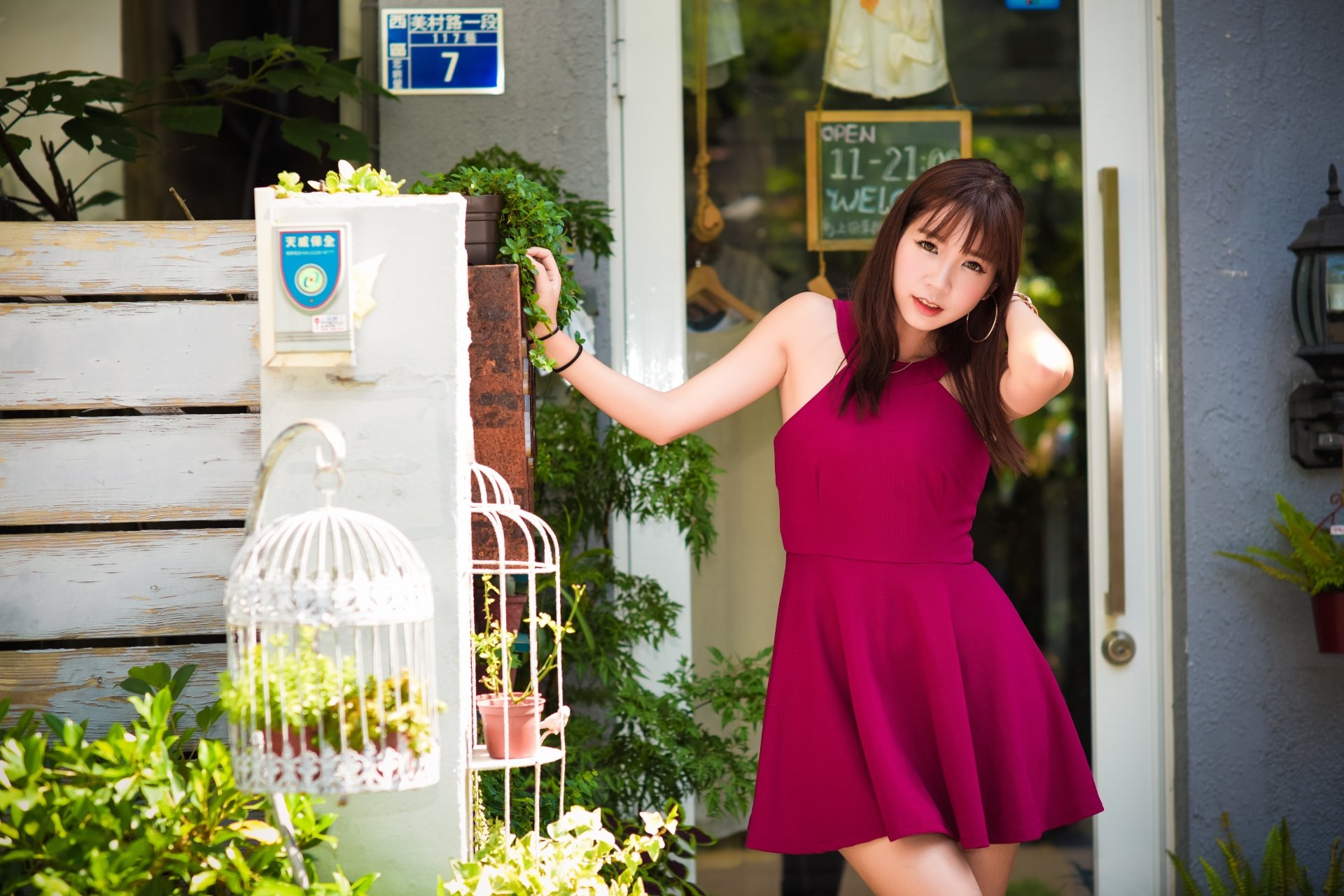 Asian woman with brunette hair wearing a pink dress poses outdoors, captured in vibrant 4K Ultra HD quality for a PC desktop wallpaper and background.