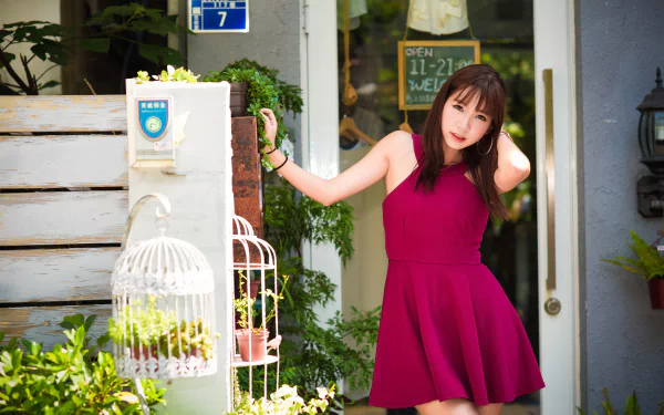 Asian woman with brunette hair wearing a pink dress poses outdoors, captured in vibrant 4K Ultra HD quality for a PC desktop wallpaper and background.