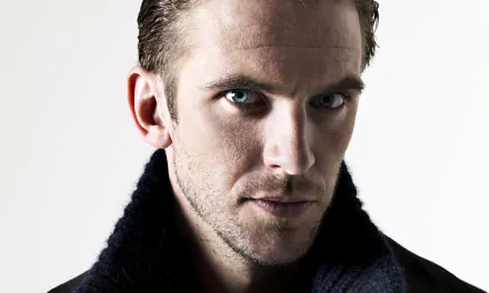 A striking HD desktop wallpaper featuring Dan Stevens, showcasing his intense gaze and sharp features, enhanced by a simple background.