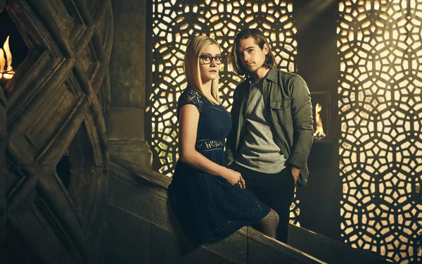 HD desktop wallpaper featuring two characters from the TV show The Magicians standing in front of an intricate patterned lighted wall.
